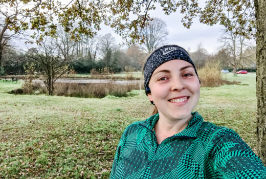 Running selfie in front of green and pond