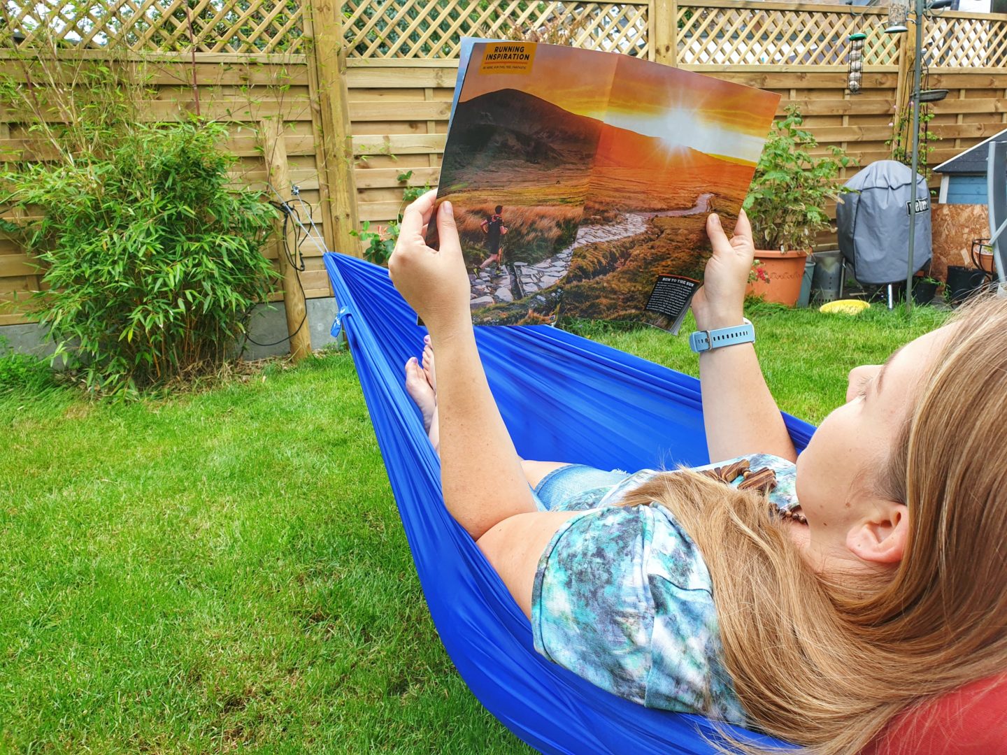 Reading a magazine in a hammock