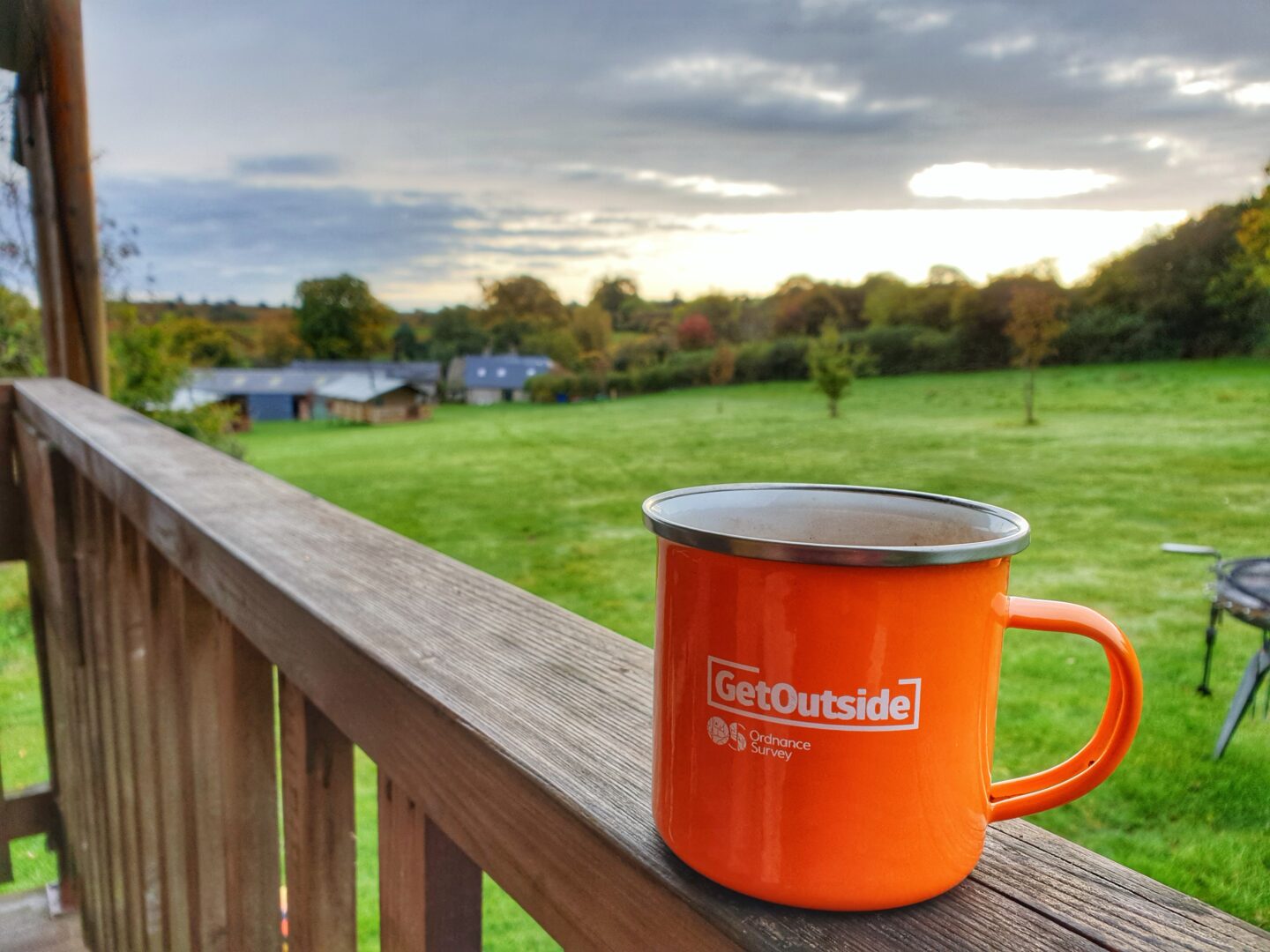 GetOutside orange mug with view of Drovers Rest glamping site