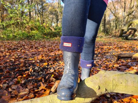 Hunter wellies shown standing on a tree branch