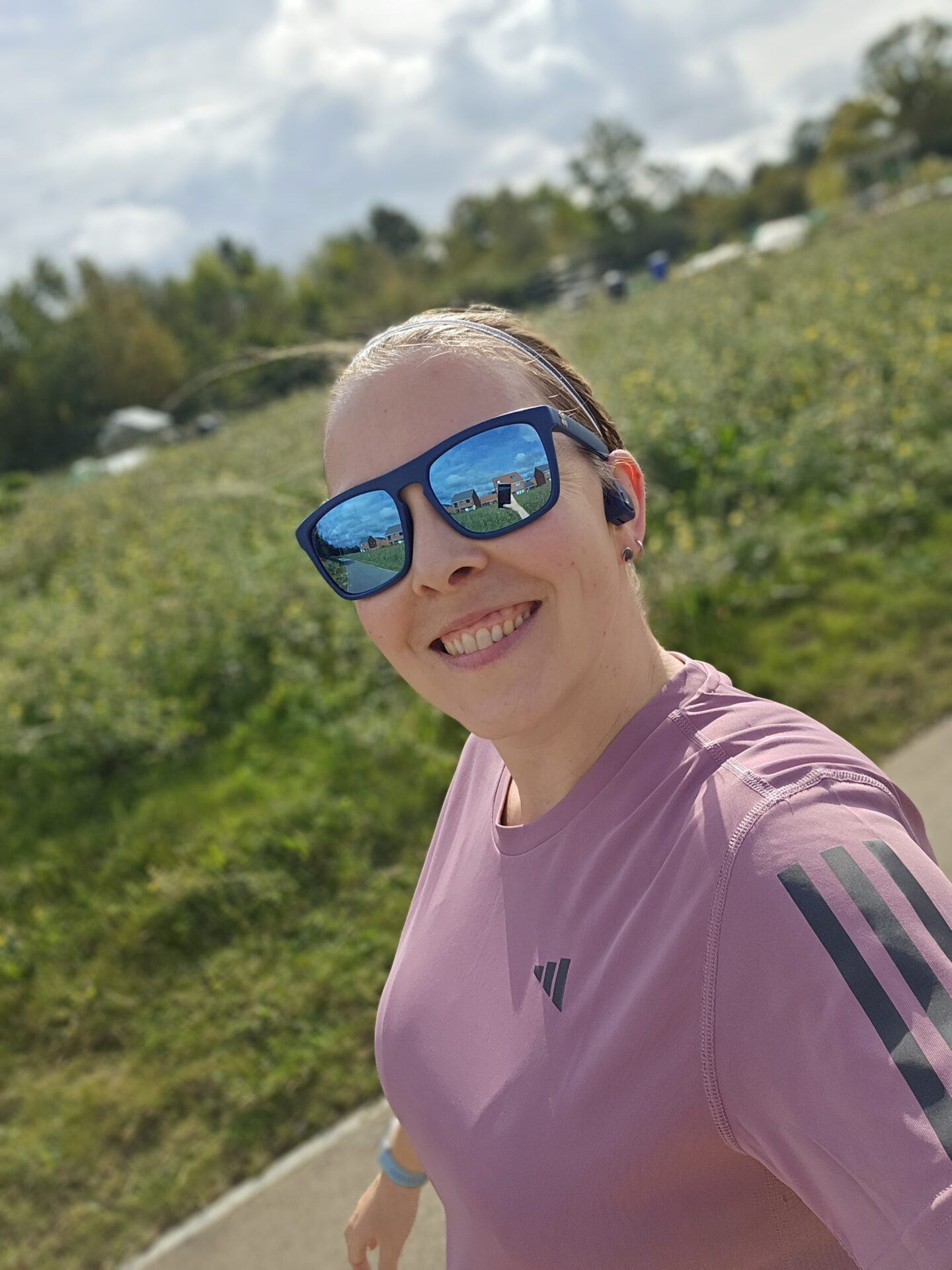 woman in purple running tshirt smiles at the camera