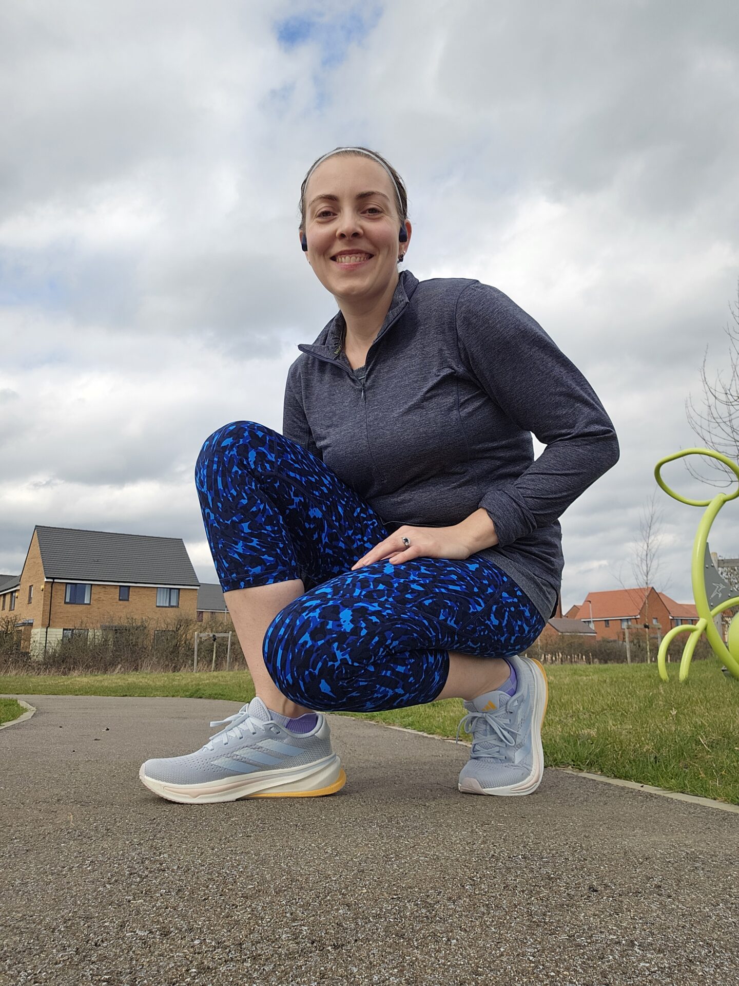 Woman kneeling down wearing running clothes